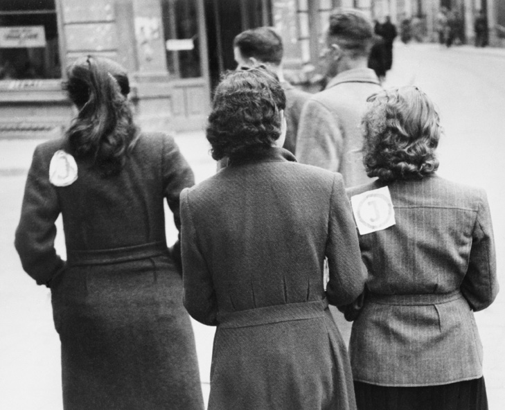 Women with ‘J’ badges stitched to their coats