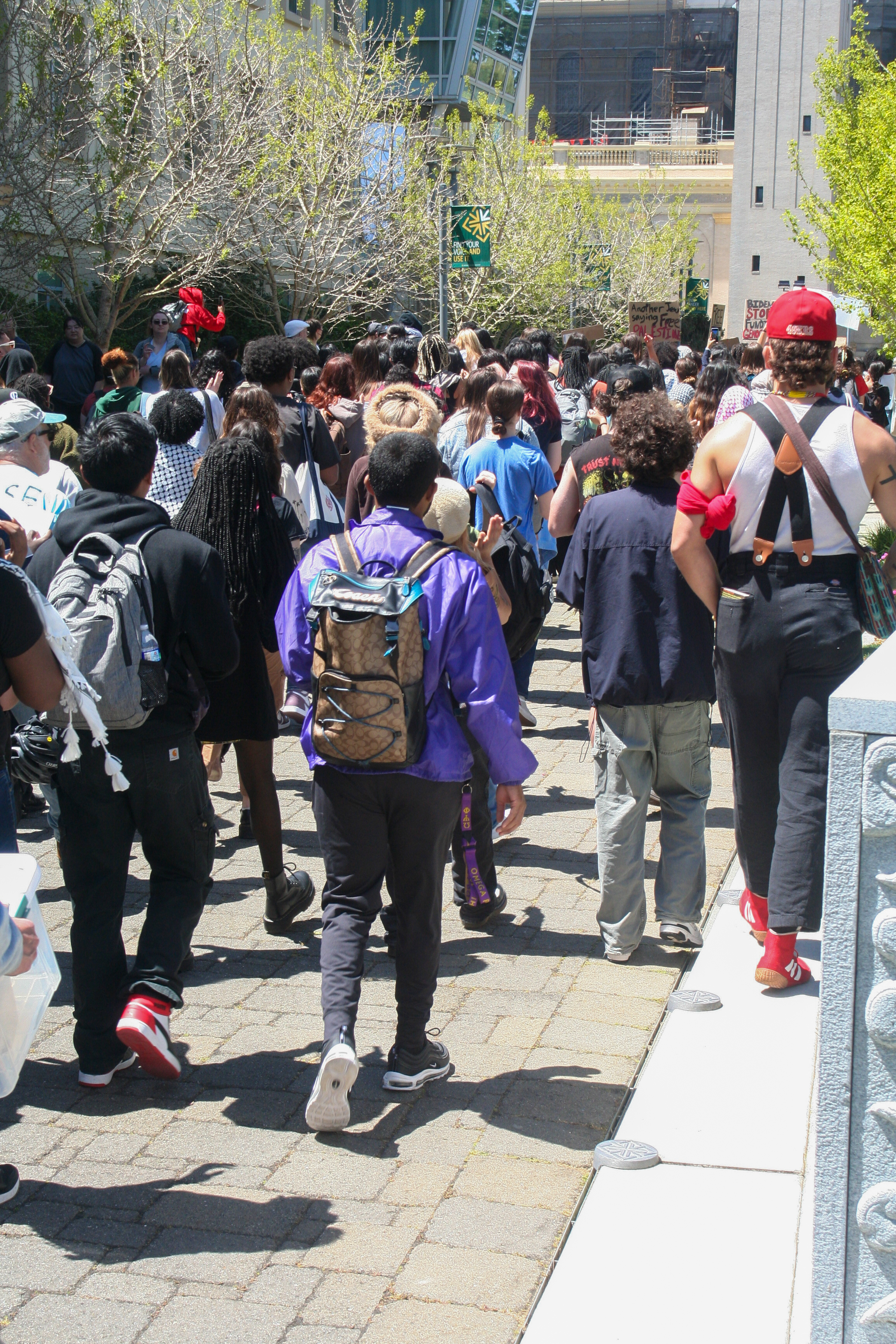 students marching to the lawn. the tail end of the crowd