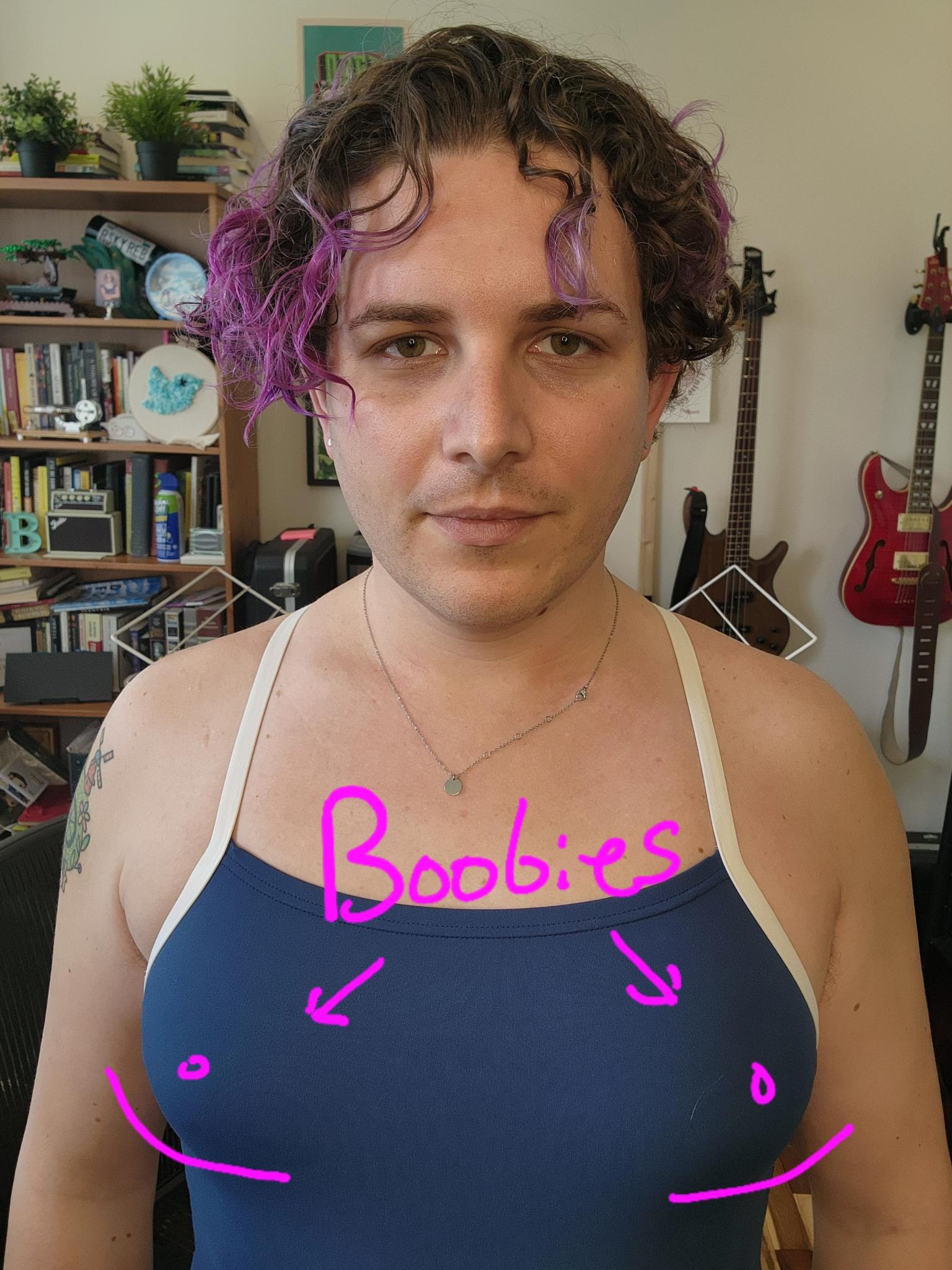 scribbles on a photo of me in a swimsuit, accentuating my breasts, with arrows pointing to them saying “boobies”